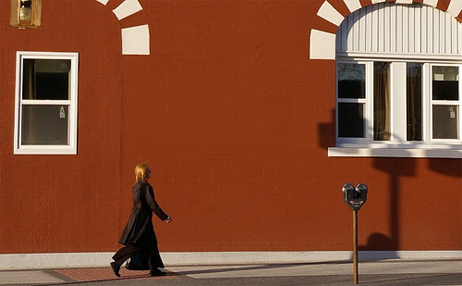 Woman walking in front of hotel