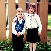 Sin�ad and Regan Siever standing in front of a brown fence